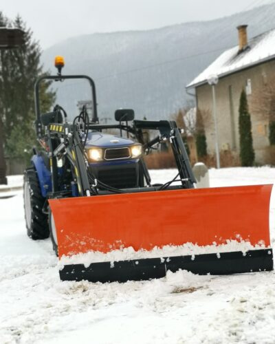 Compact tractor with a plow